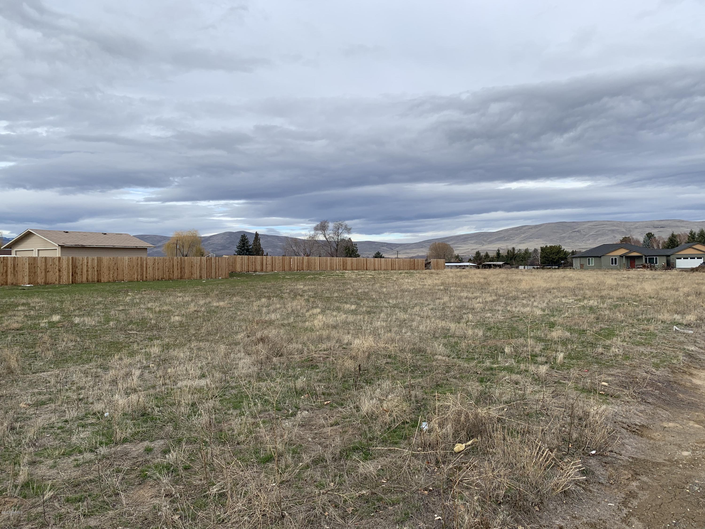 15095 Fisk Road Yakima, WA 98908 - Photo 2 of 2 a view of a large body of water with a building in the background