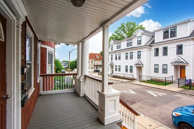 a view of a house with a floor to ceiling window and wooden floor
