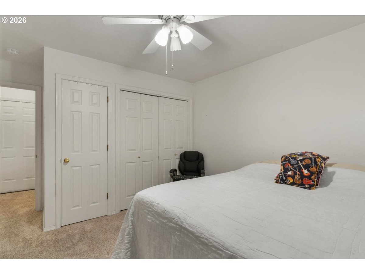 468 Harris Lane Oregon City, OR 97045 - Photo 18 of 34 a bedroom with a bed and a chandelier fan