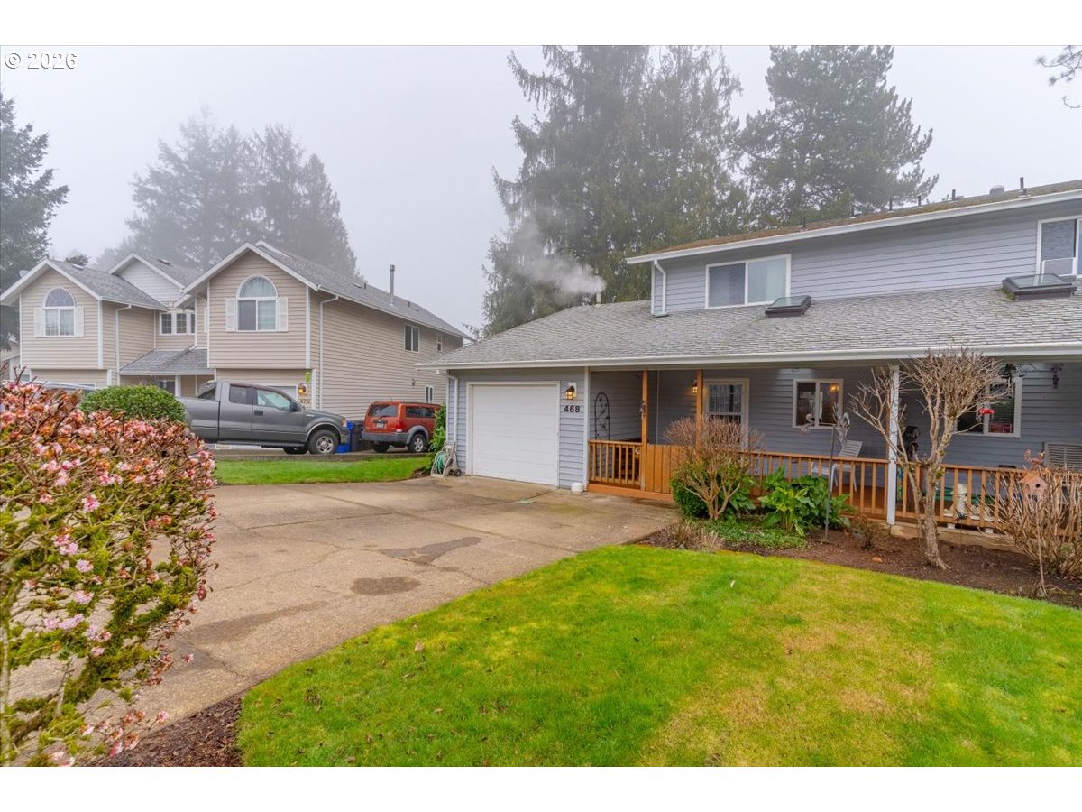 468 Harris Lane Oregon City, OR 97045 - Photo 4 of 34 a front view of a house with a garden and porch