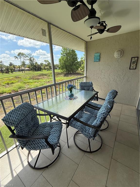 760 Augusta Boulevard, Unit D204 Naples, FL 34113 - Photo 13 of 32 a view of a chairs and table in patio