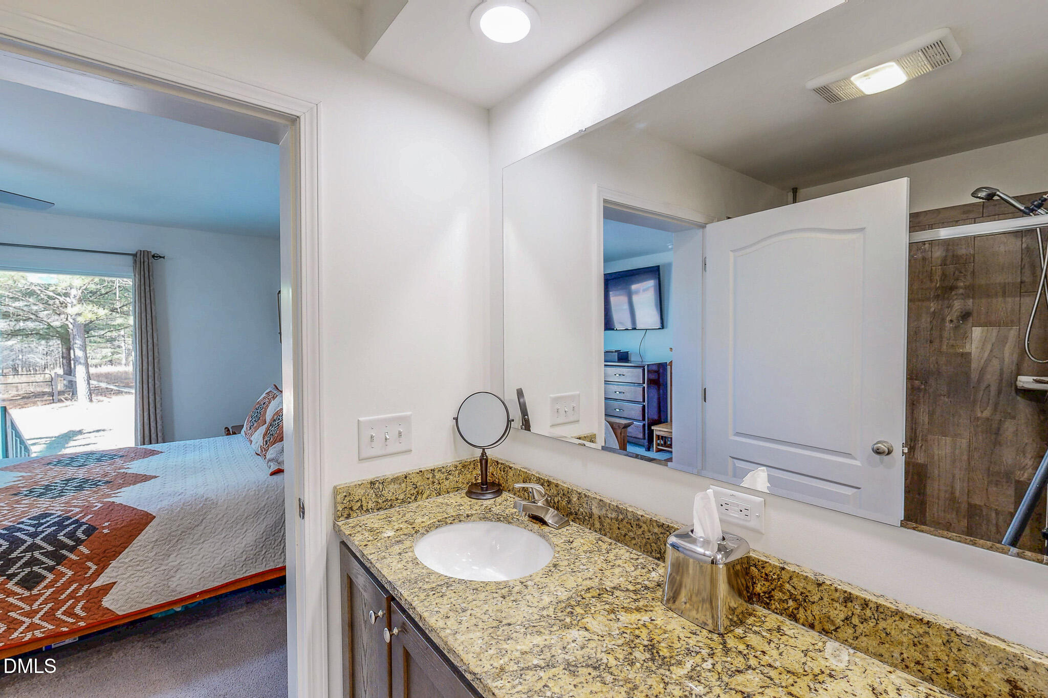 125 Ninovan Place Rougemont, NC 27572 - Photo 29 of 55 a bedroom with a granite countertop sink and a mirror
