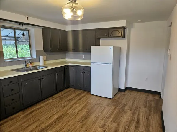 a kitchen with a sink stove and cabinets
