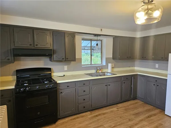 a kitchen with wooden cabinets and refrigerator