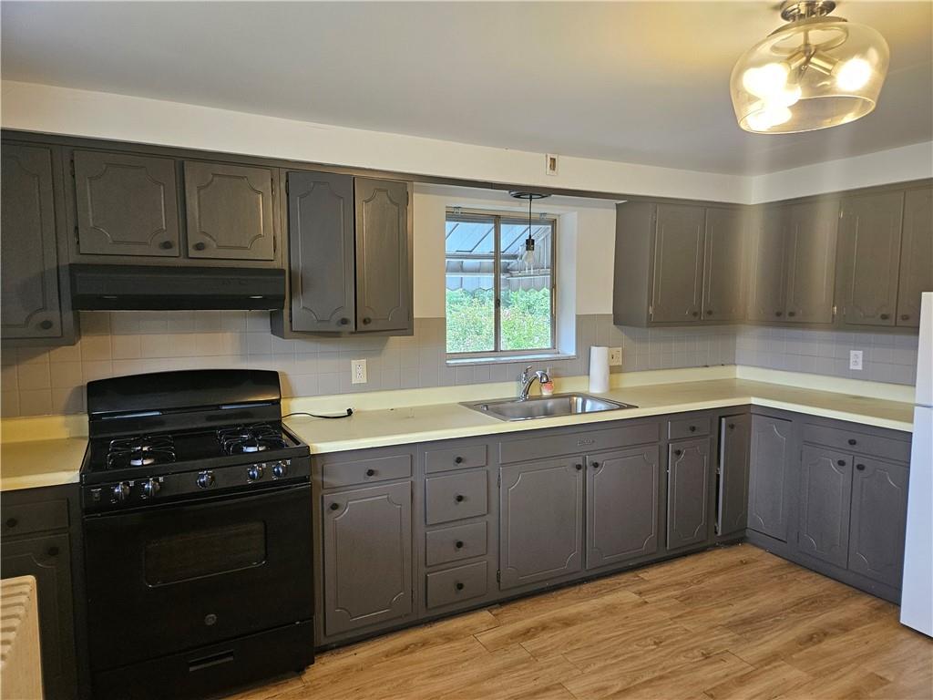 537 6th Street Braddock, PA 15104 - Photo 14 of 38 a kitchen with a sink stove and cabinets