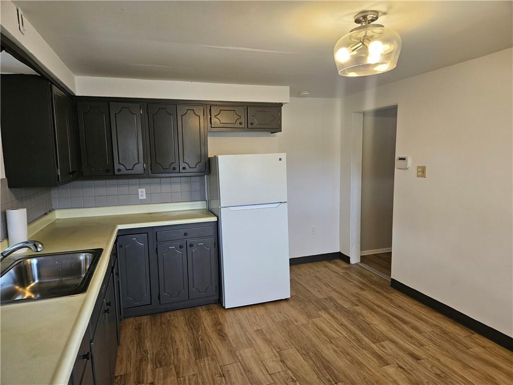 537 6th Street Braddock, PA 15104 - Photo 15 of 38 a kitchen with wooden cabinets and refrigerator