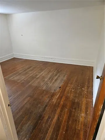 a view of an empty room and wooden floor
