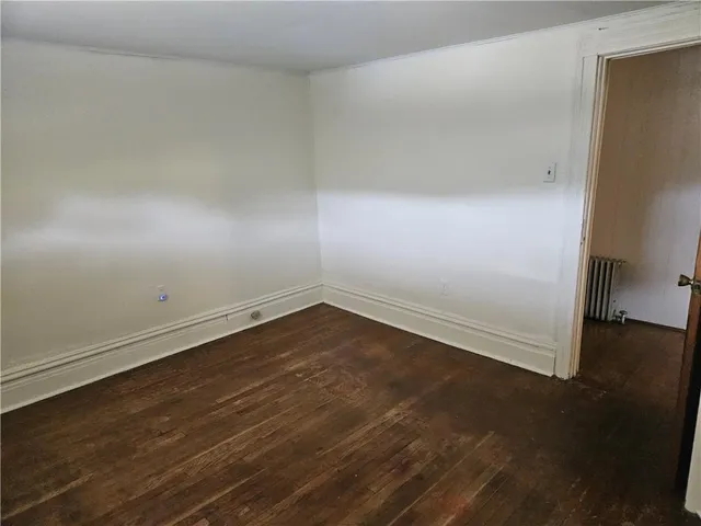 a bathroom with a tub shower and toilet