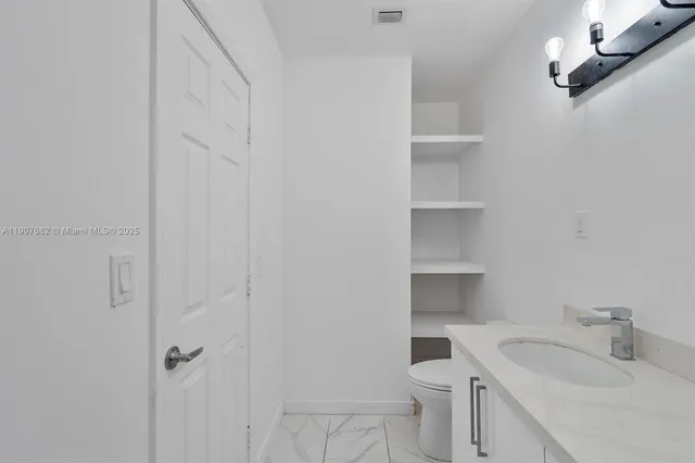 a bathroom with a sink toilet and vanity
