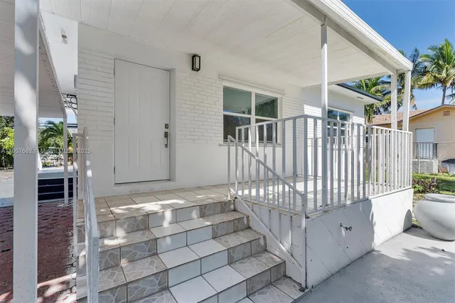 a view of an entryway with a door and wooden floor