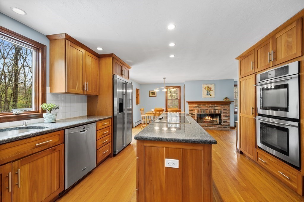 21 Adams Road Boxford, MA 01921 - Photo 5 of 40 a kitchen with stainless steel appliances granite countertop a sink stove and refrigerator
