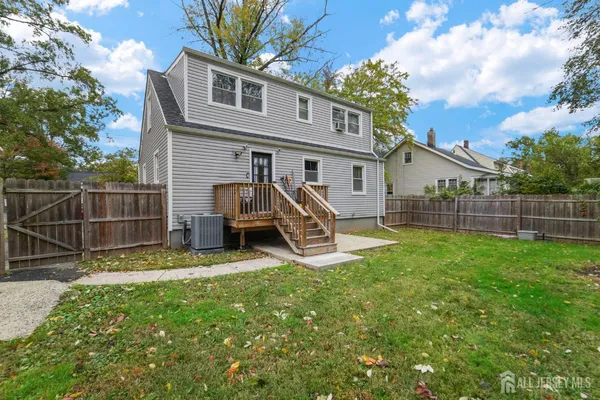 a view of a house with a yard and sitting area