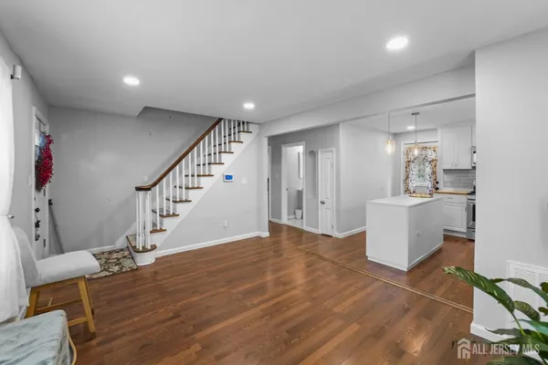 a view of a livingroom with wooden floor and furniture