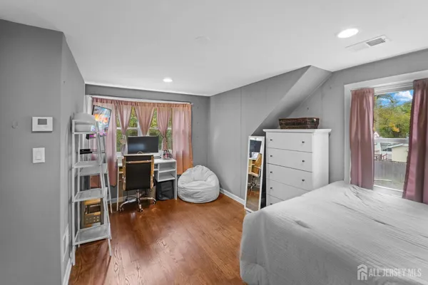 a bedroom with furniture and a window