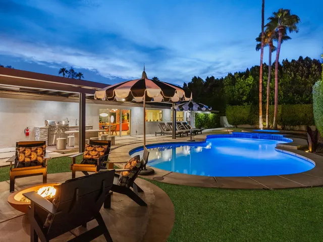 a view of a patio with swimming pool table and chairs