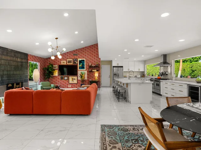 a living room with furniture and kitchen view