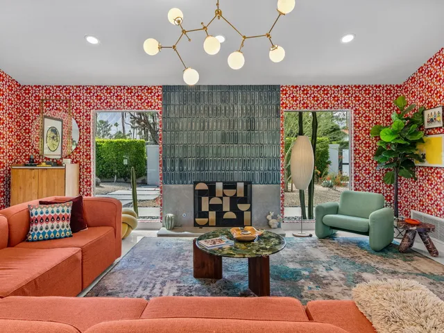 a living room with furniture a chandelier and a large window