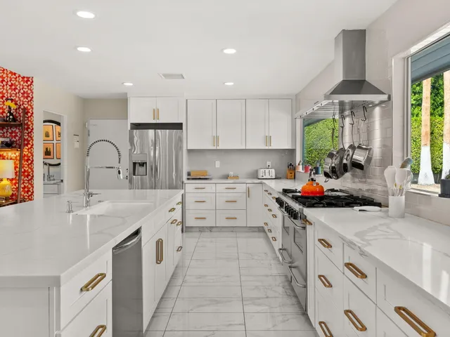 a kitchen with stainless steel appliances granite countertop a sink counter space cabinets and a large window