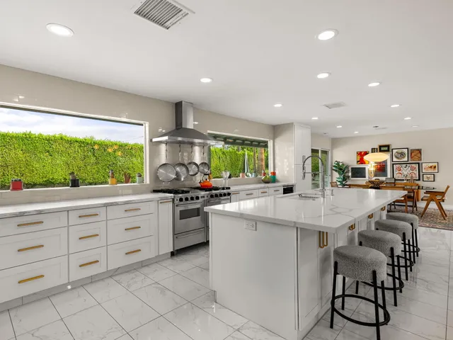 a kitchen with stainless steel appliances kitchen island granite countertop a sink and cabinets