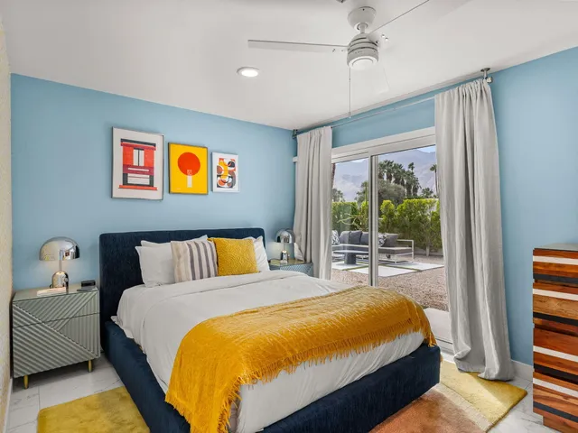 a bed sitting in a bedroom next to a window