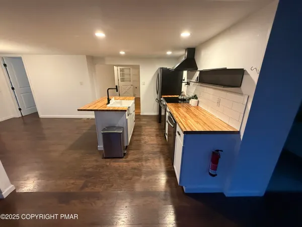 a kitchen with a sink a microwave a counter top space and cabinets