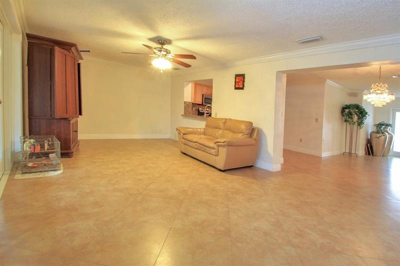 98 Seminole Lane Boca Raton, FL 33487 - Photo 9 of 42 a living room with furniture and a chandelier
