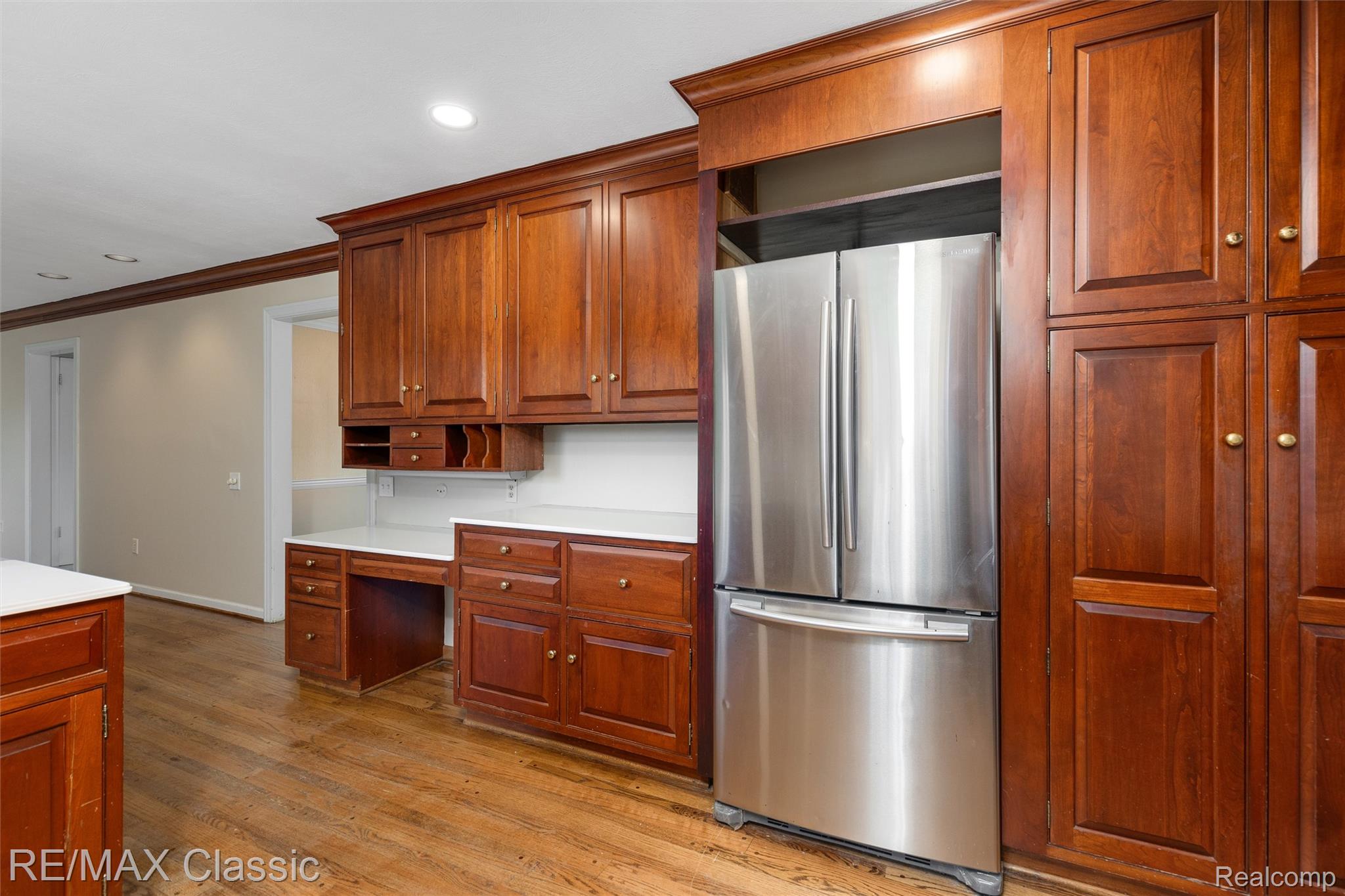 4268 Covered Bridge Road Bloomfield Hills, MI 48302 - Photo 4 of 35 Kitchen featuring built-in cherry wood cabinetry, a stainless steel French door refrigerator, white countertops, and wood-finish flooring