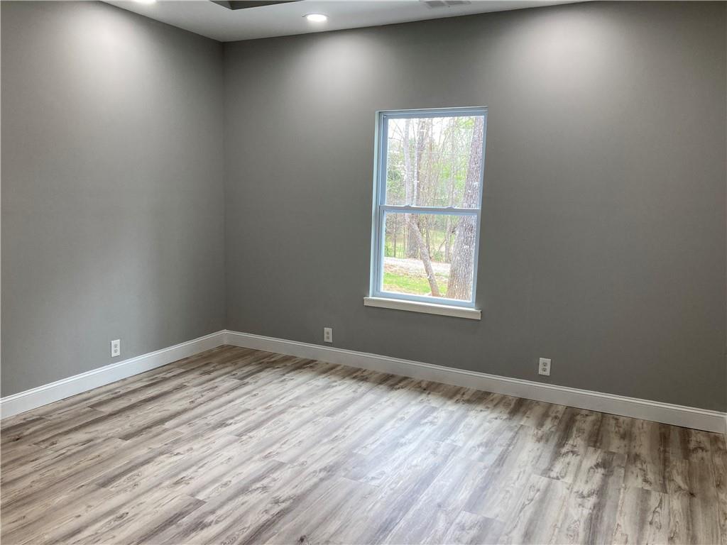 100 A Dickerson Road Dahlonega, GA 30533 - Photo 9 of 15 an empty room with wooden floor and windows