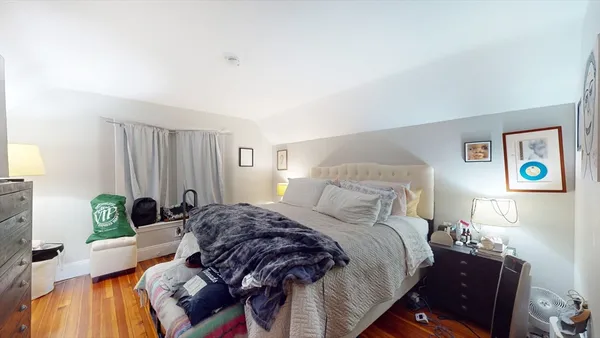 a bedroom with a bed and a couch