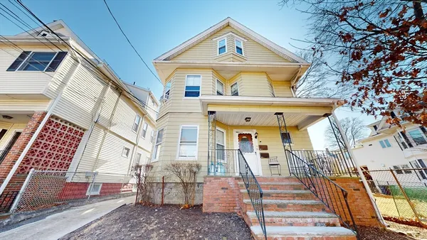 a view of a brick house with large windows
