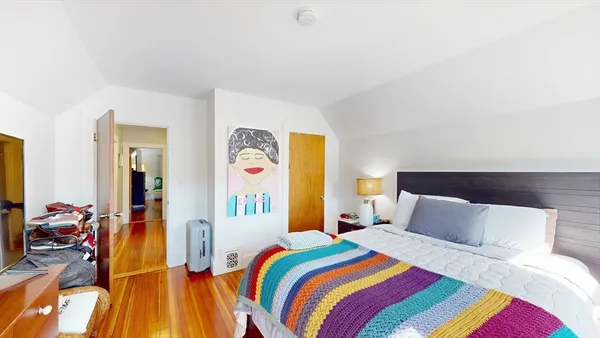 a bedroom with a bed and a couch