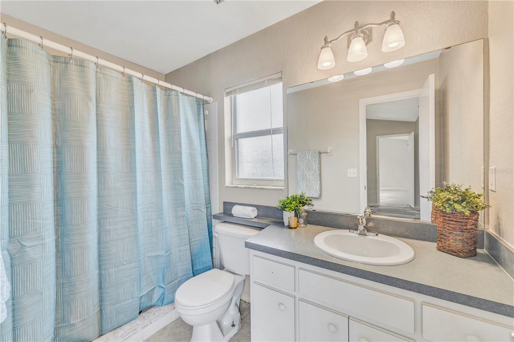 601 Parsons Reserve Court Seffner, FL 33584 - Photo 14 of 21 a bathroom with a granite countertop sink a toilet and a mirror
