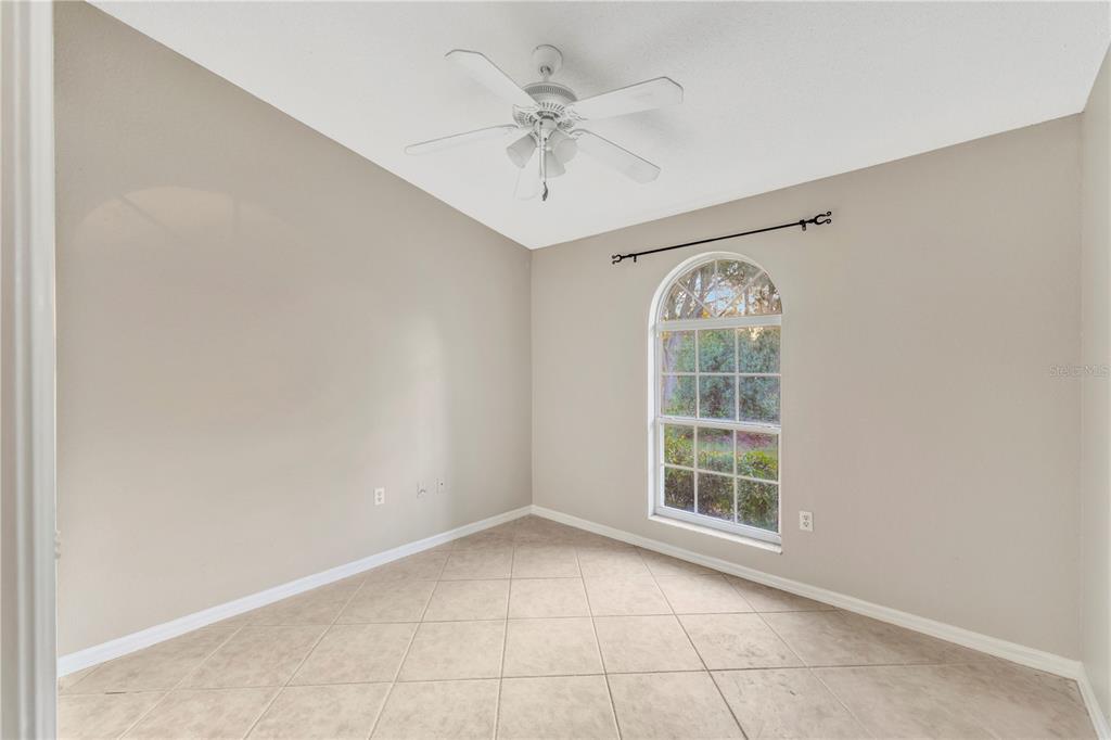 601 Parsons Reserve Court Seffner, FL 33584 - Photo 15 of 21 an empty room with windows and ceiling fan