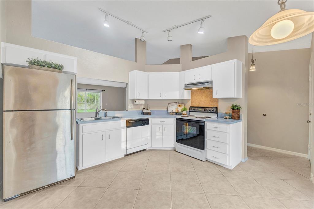 601 Parsons Reserve Court Seffner, FL 33584 - Photo 5 of 21 a kitchen with granite countertop a refrigerator oven a sink a stove and a refrigerator