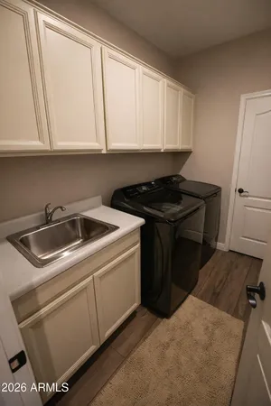 a kitchen with granite countertop white cabinets and black appliances