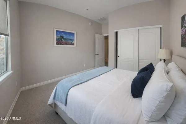 a bedroom with a bed and a window