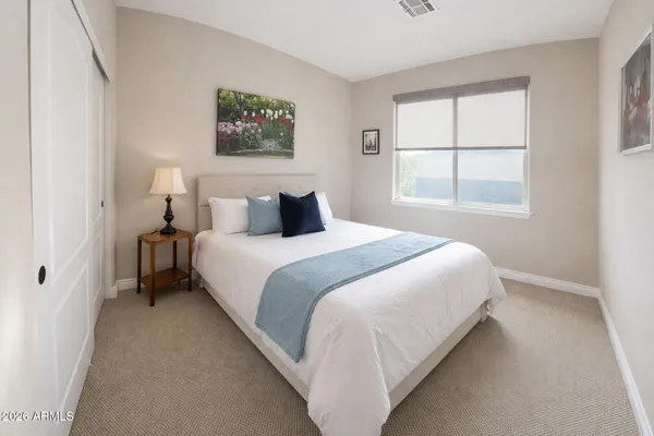 a bedroom with a bed and a window