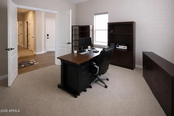 a view of a workspace with furniture and cabinet