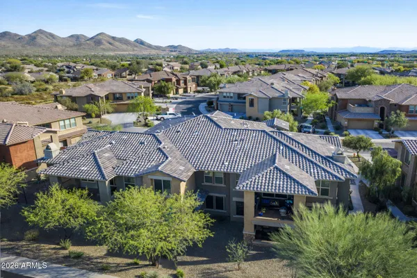 an aerial view of multiple house houses with a garden