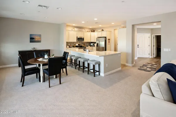 a large white kitchen with a table and chairs