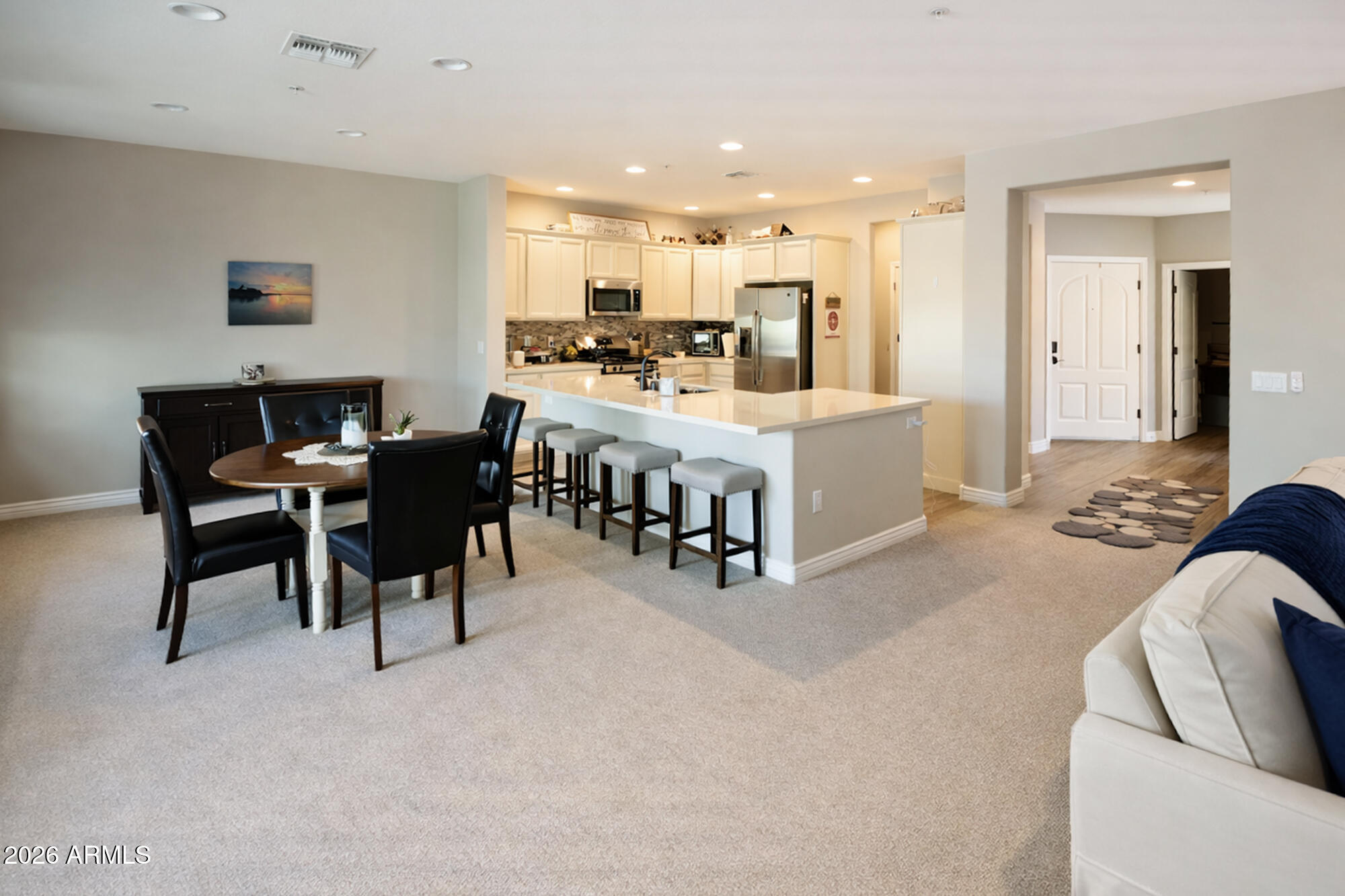 2425 West Bronco Butte Trail, Unit 2007 Phoenix, AZ 85085 - Photo 5 of 30 a large white kitchen with a table and chairs
