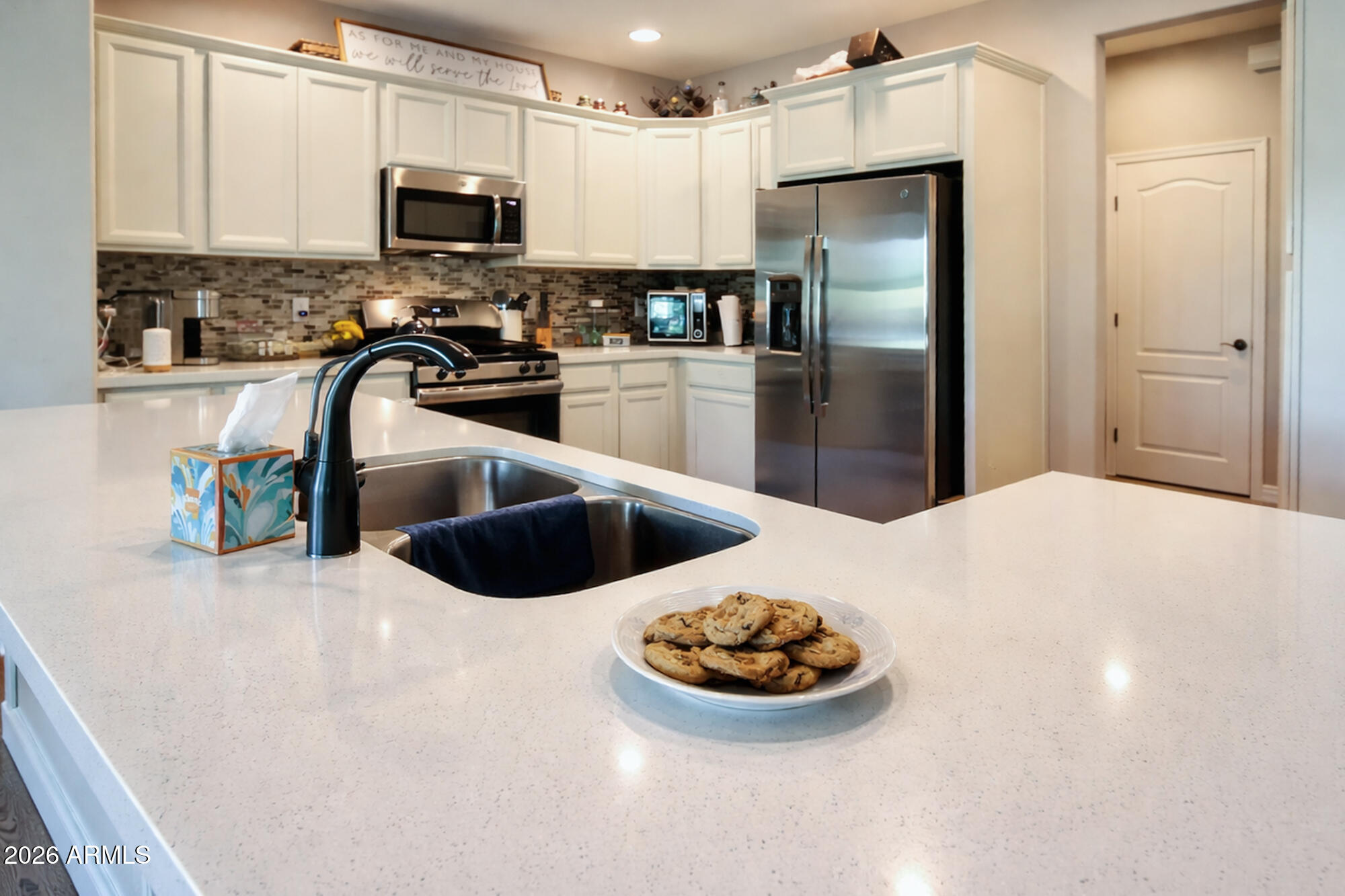 2425 West Bronco Butte Trail, Unit 2007 Phoenix, AZ 85085 - Photo 6 of 30 a kitchen with stainless steel appliances a refrigerator sink and stove