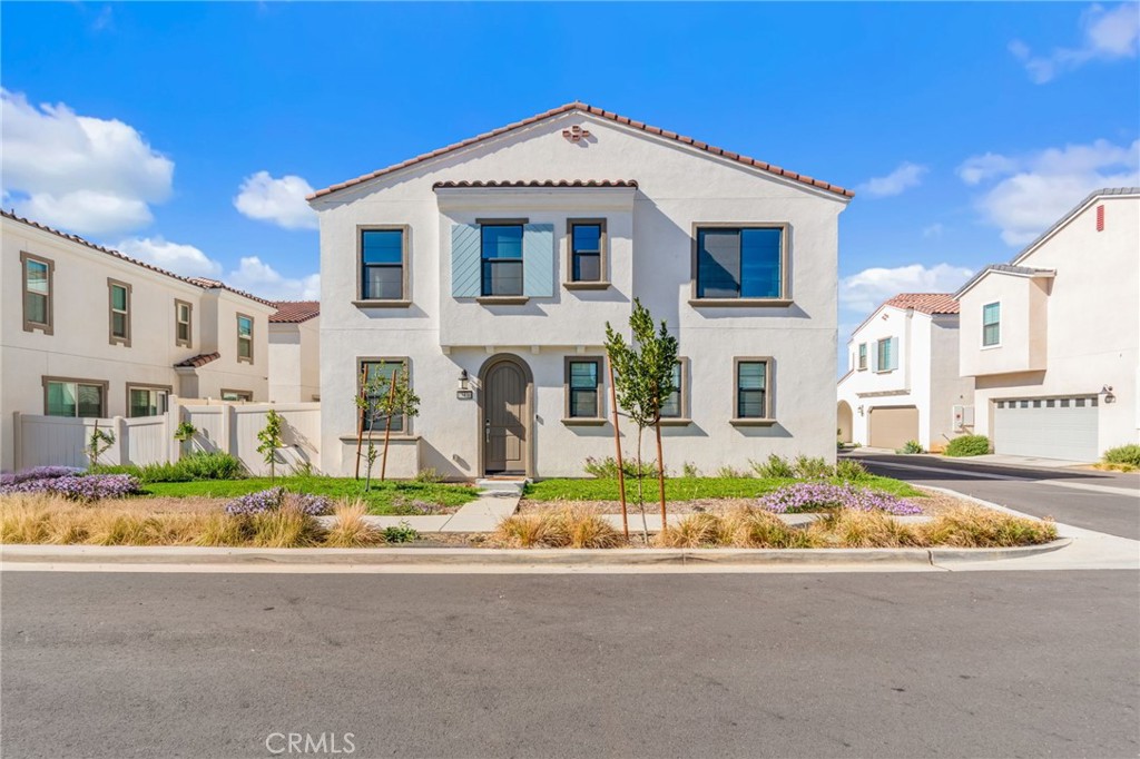 a view of white house with a yard