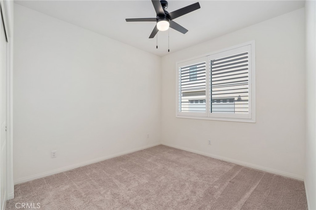 13430 Limestone Drive Yucaipa, CA 92399 - Photo 11 of 30 an empty room with windows and fan