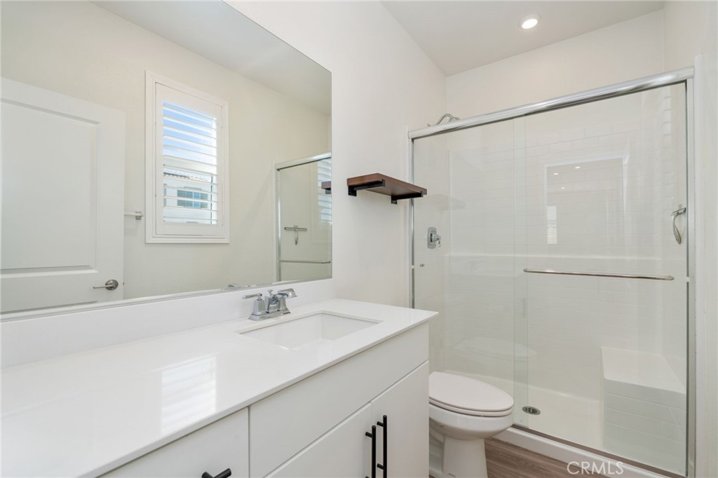 13430 Limestone Drive Yucaipa, CA 92399 - Photo 13 of 30 a bathroom with a sink a toilet and shower