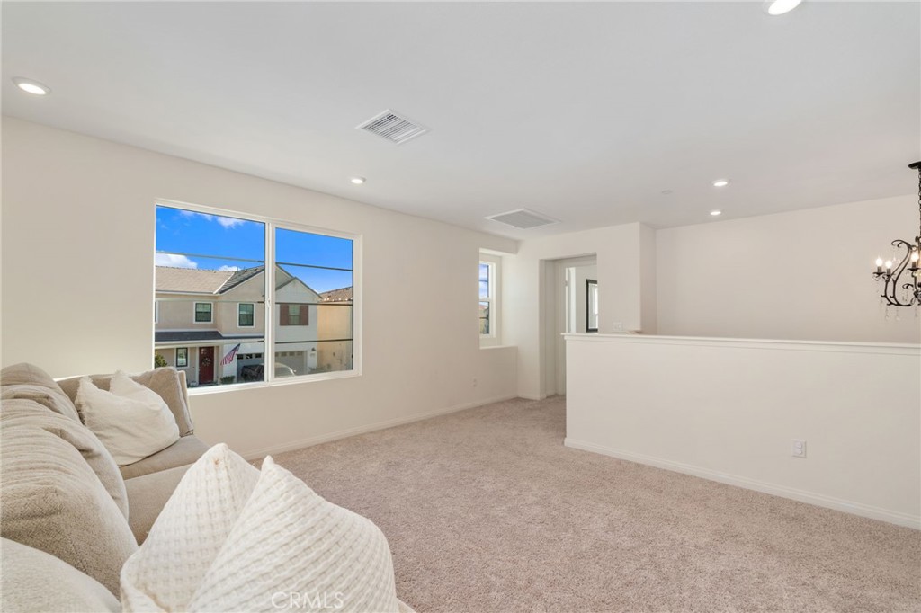 13430 Limestone Drive Yucaipa, CA 92399 - Photo 16 of 30 a living room with furniture and a floor to ceiling window