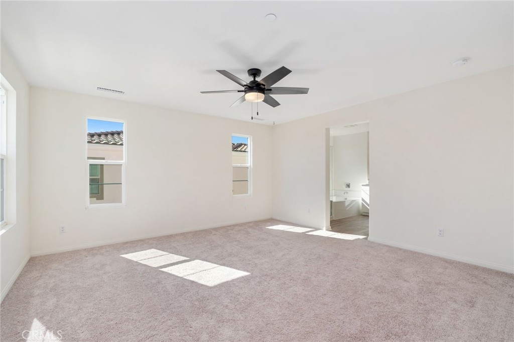 13430 Limestone Drive Yucaipa, CA 92399 - Photo 18 of 30 a view of a room with a ceiling fan and window
