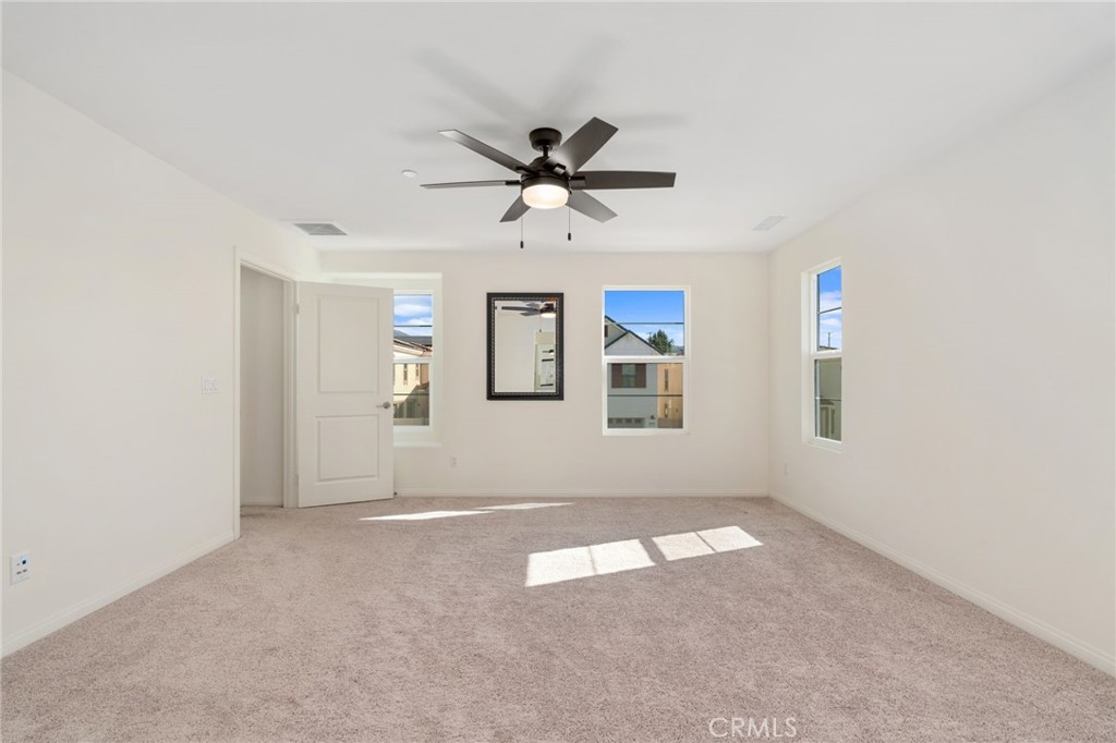 13430 Limestone Drive Yucaipa, CA 92399 - Photo 19 of 30 an empty room with windows and fan