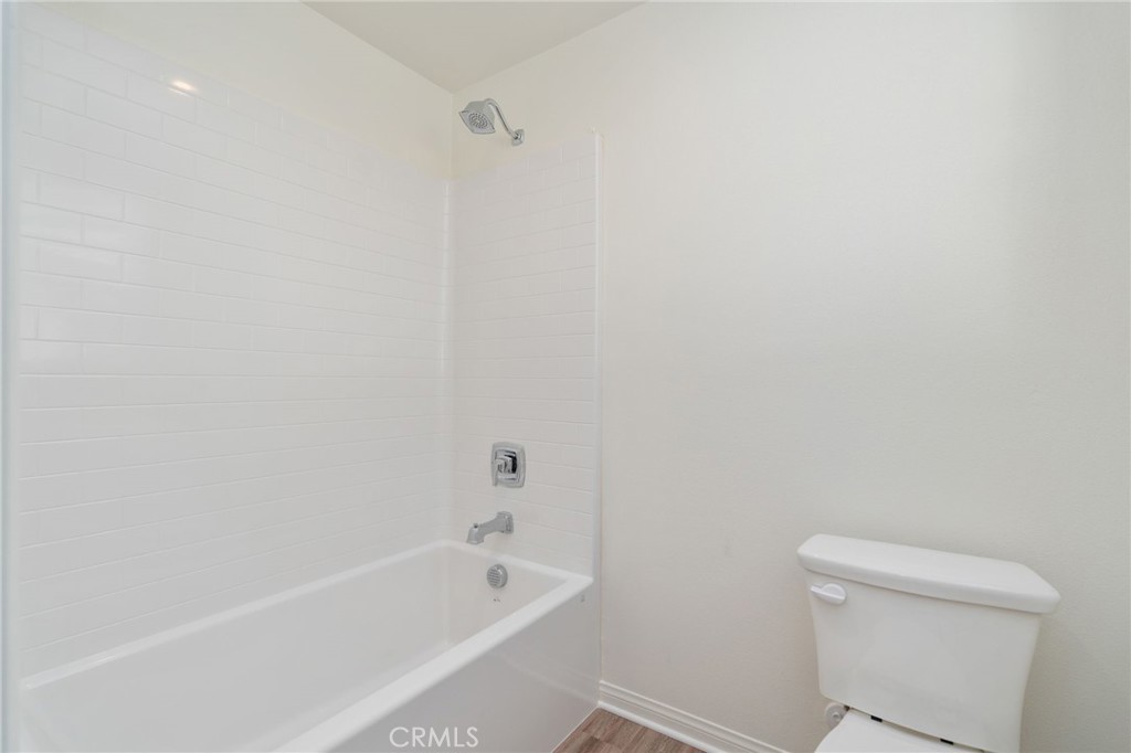 13430 Limestone Drive Yucaipa, CA 92399 - Photo 26 of 30 a white bath tub sitting next to a toilet