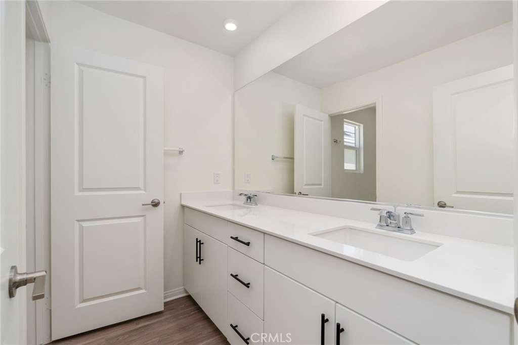 13430 Limestone Drive Yucaipa, CA 92399 - Photo 27 of 30 a bathroom with a double vanity sink and mirror